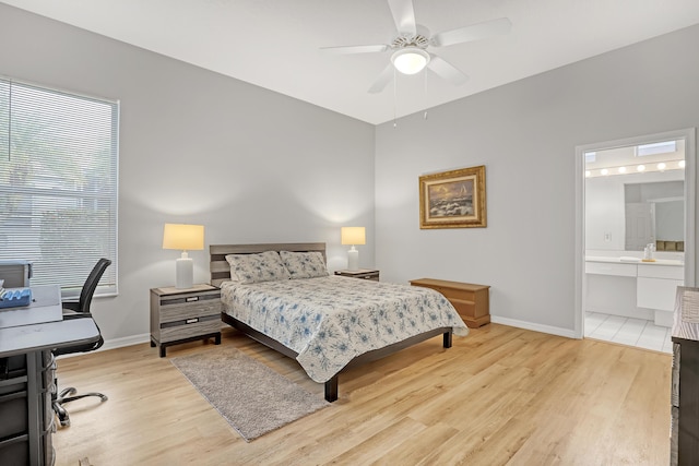 bedroom featuring connected bathroom, light hardwood / wood-style flooring, and ceiling fan