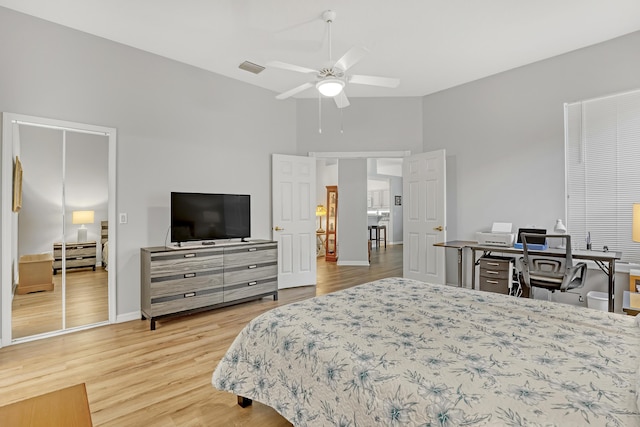 bedroom with visible vents, light wood-style flooring, a ceiling fan, high vaulted ceiling, and baseboards