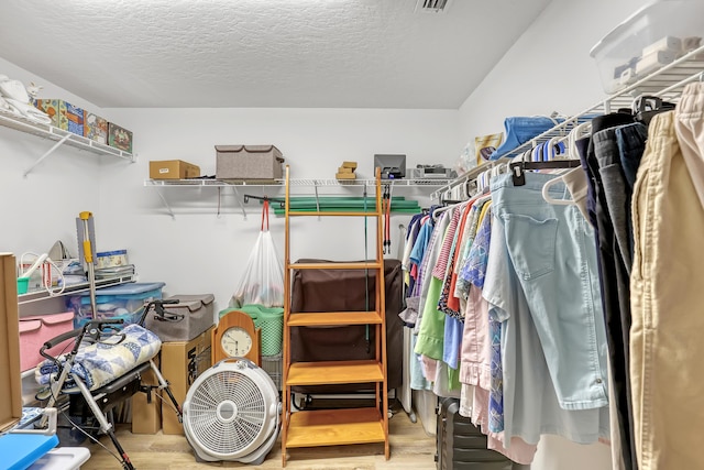 spacious closet with light wood-style flooring and visible vents