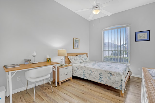 bedroom with baseboards and light wood finished floors