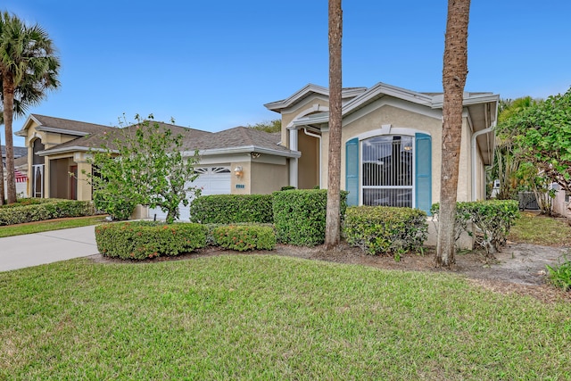 view of front of home with a garage and a front lawn