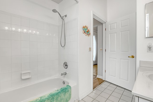 bathroom with tile patterned flooring, vanity, and tiled shower / bath