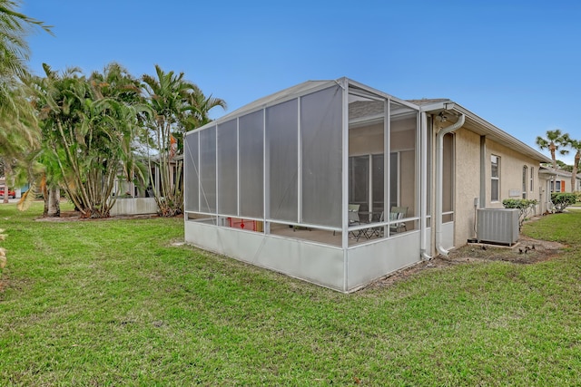 view of property exterior with a yard and central air condition unit