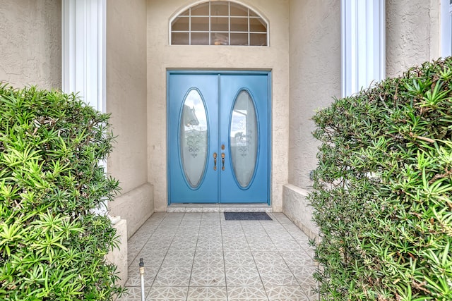 entrance to property featuring stucco siding