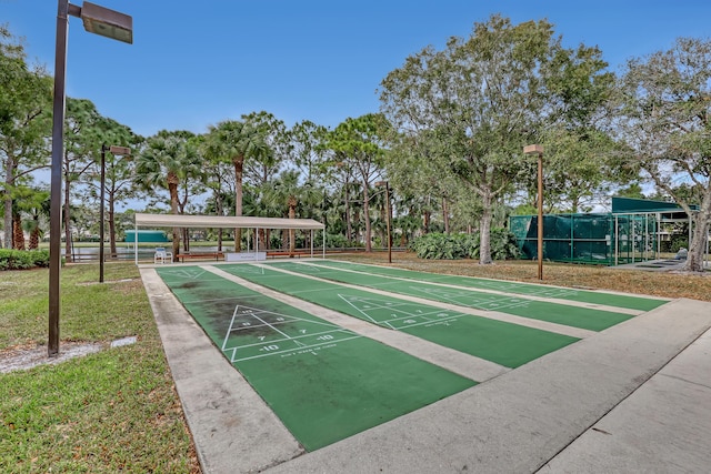 view of home's community featuring shuffleboard and fence