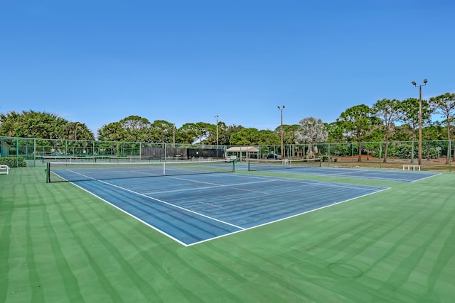 view of tennis court with fence