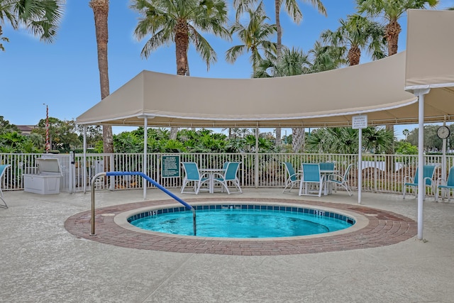 view of swimming pool featuring a hot tub