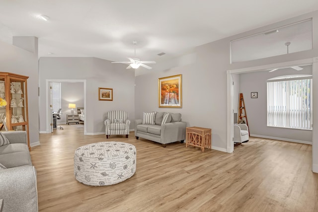 living area with light wood-type flooring, visible vents, ceiling fan, and baseboards