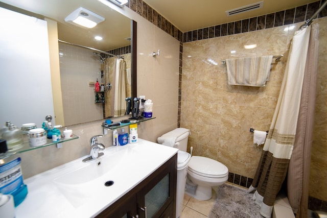 bathroom featuring tile patterned flooring, tile walls, a shower with curtain, and toilet