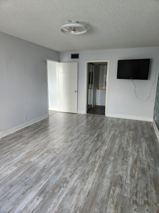 interior space featuring hardwood / wood-style floors and a textured ceiling