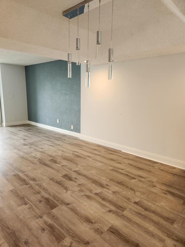 interior space with hardwood / wood-style floors and a textured ceiling