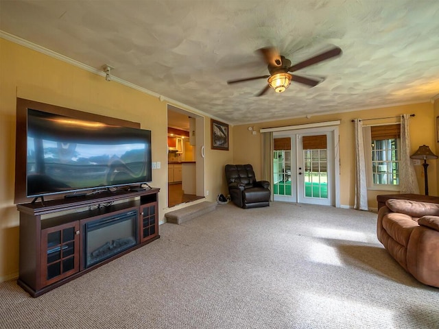 living room featuring french doors, carpet floors, ceiling fan, and ornamental molding