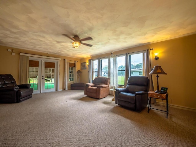 living area with carpet, french doors, and ceiling fan