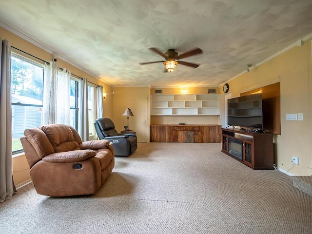 living room with carpet, ceiling fan, and ornamental molding