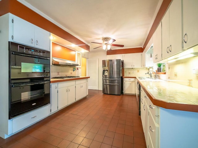 kitchen with black appliances, sink, tasteful backsplash, white cabinetry, and extractor fan