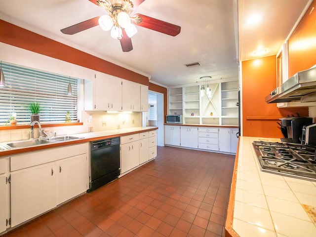 kitchen with sink, ceiling fan, appliances with stainless steel finishes, tile counters, and white cabinetry