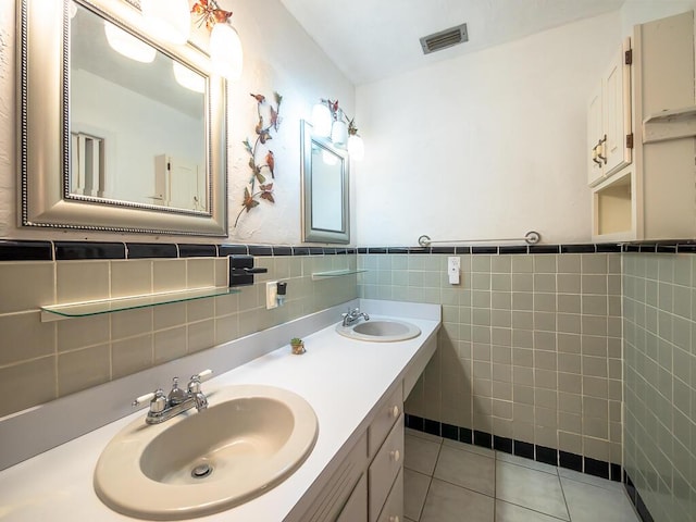 bathroom with tile patterned floors, vanity, and tile walls