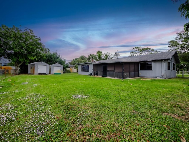 yard at dusk featuring an outbuilding