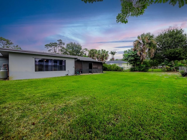 view of yard at dusk