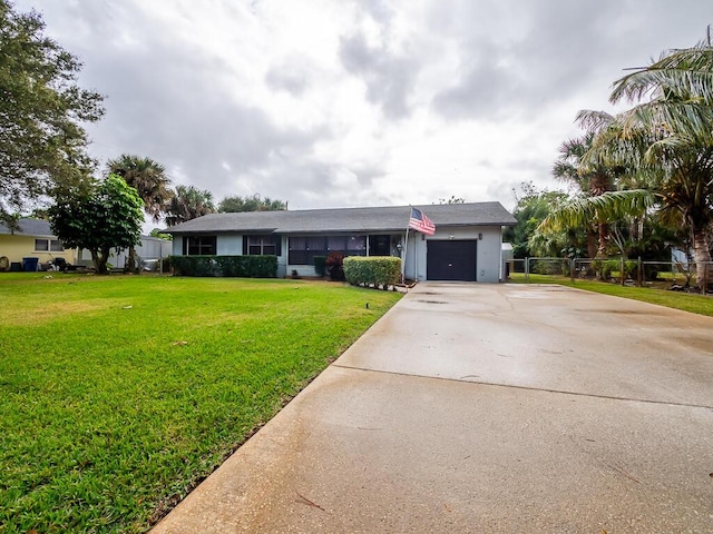 single story home with a front yard and a garage