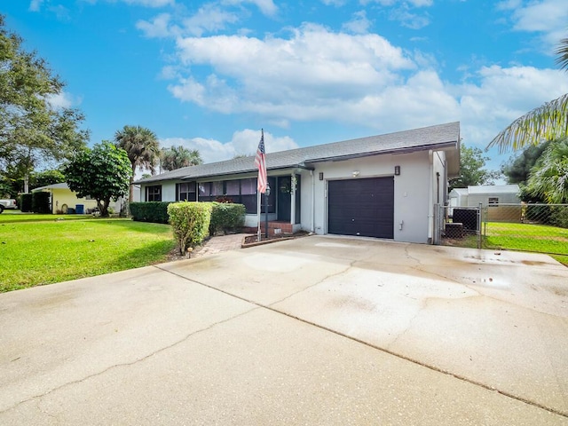 ranch-style house with a garage and a front lawn