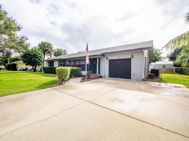 ranch-style house featuring a garage and a front yard