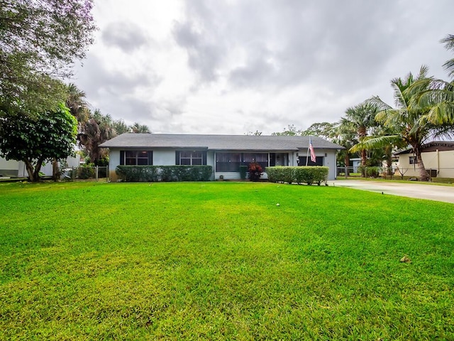 ranch-style house with a front lawn