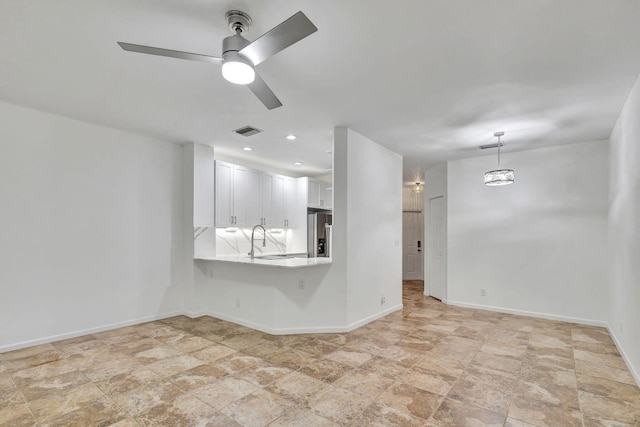 empty room with ceiling fan and sink