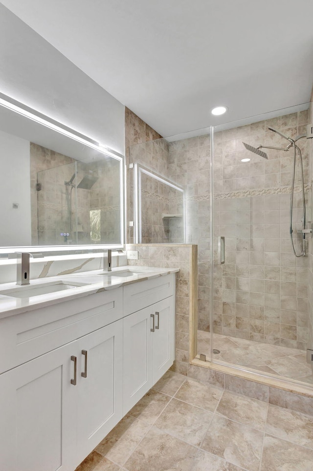 bathroom with vanity and a shower with shower door