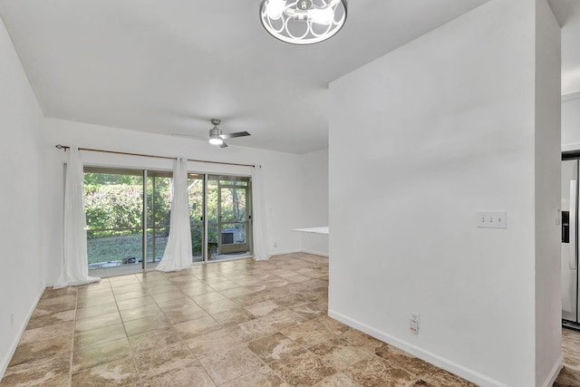 unfurnished room featuring ceiling fan with notable chandelier