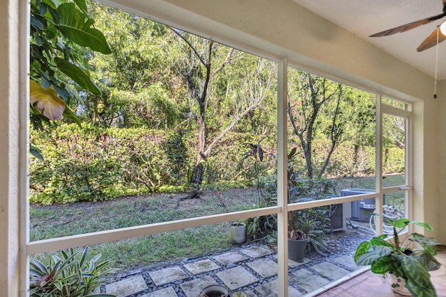 unfurnished sunroom featuring ceiling fan