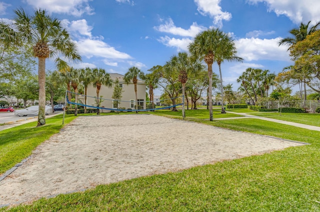 view of property's community with volleyball court and a yard