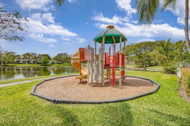 view of play area featuring a lawn and a water view