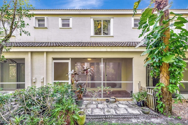 rear view of property with a sunroom