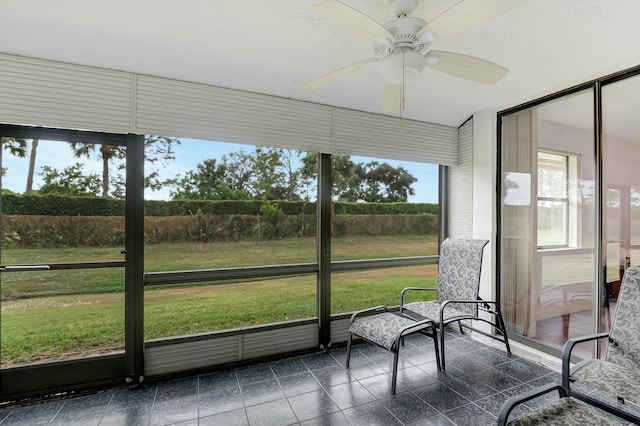 sunroom featuring ceiling fan and a wealth of natural light