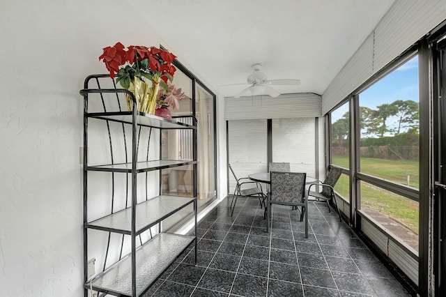 sunroom featuring ceiling fan