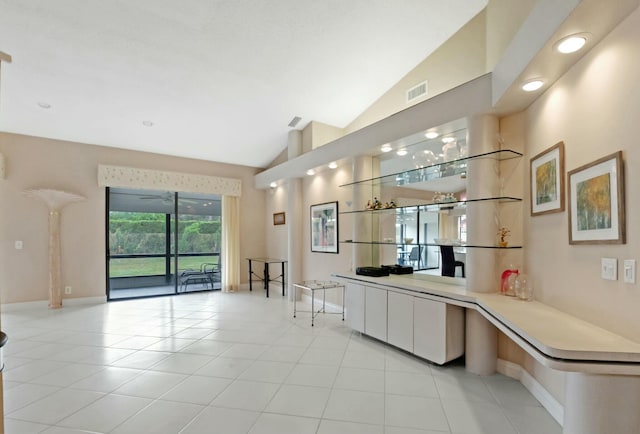 kitchen with light tile patterned flooring and lofted ceiling