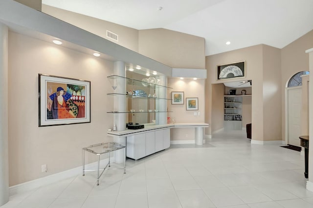 interior space with light tile patterned flooring and lofted ceiling