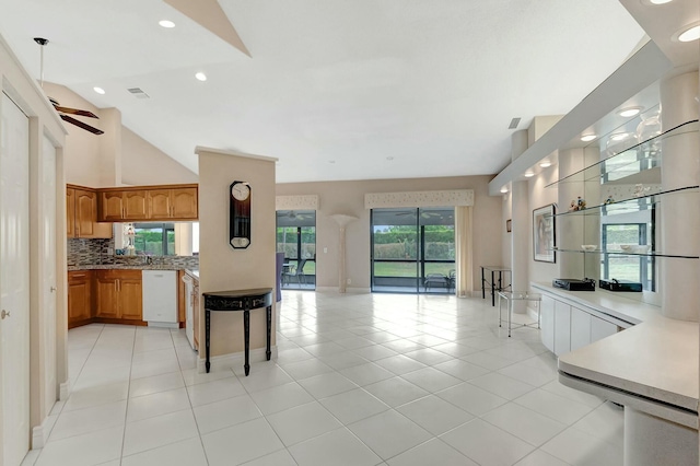 kitchen featuring ceiling fan, dishwasher, decorative backsplash, high vaulted ceiling, and light tile patterned floors