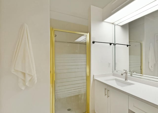 bathroom with a shower with shower door and vanity