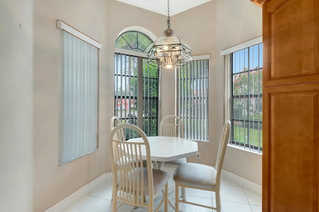 dining room with light tile patterned flooring and a notable chandelier