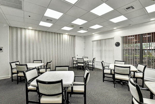 dining space with a drop ceiling