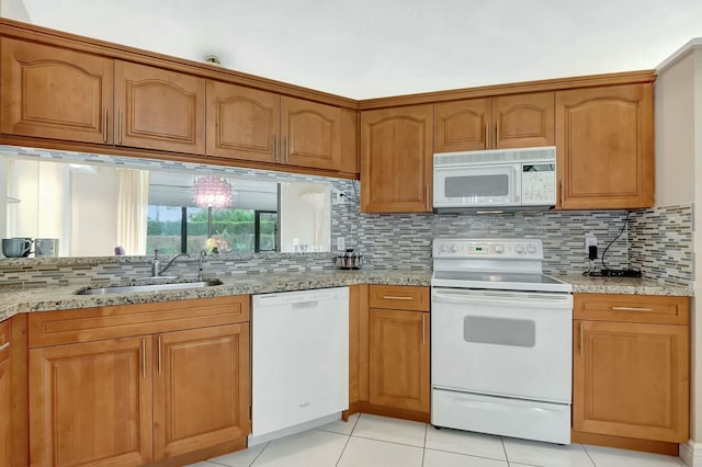 7676 Lexington Club Blvd Unit A, Delray Beach, FL 33446 - kitchen featuring white appliances, light stone countertops, a sink, tasteful backsplash, and light tile patterned flooring