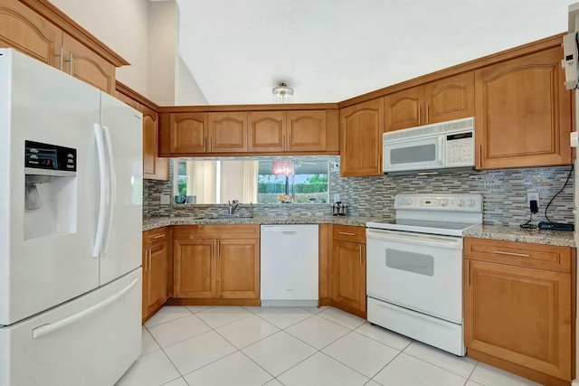 kitchen with decorative backsplash, sink, white appliances, light stone countertops, and light tile patterned floors