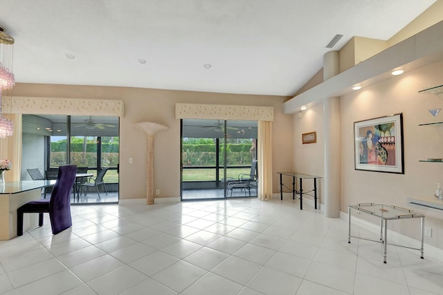 living room with ceiling fan, vaulted ceiling, and light tile patterned flooring