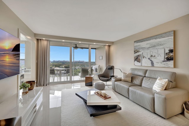 living room with floor to ceiling windows and light tile patterned floors