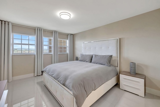 tiled bedroom featuring multiple windows