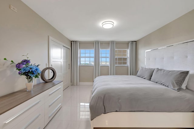 bedroom with light tile patterned floors