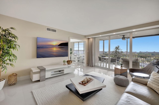 tiled living room with expansive windows and plenty of natural light