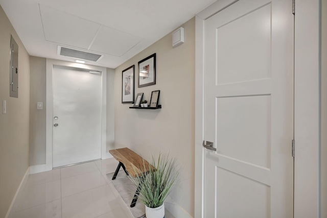 corridor featuring light tile patterned floors and electric panel